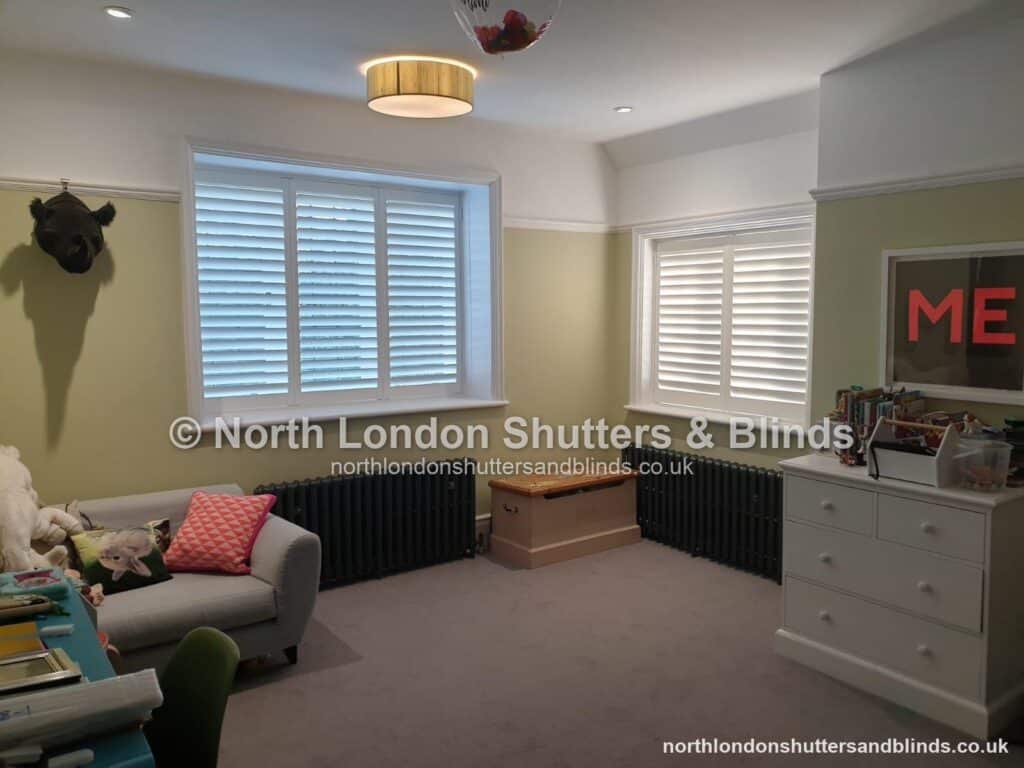 White full height plantation shutters on two windows in a living room by shutter fitters in Barnet, North London