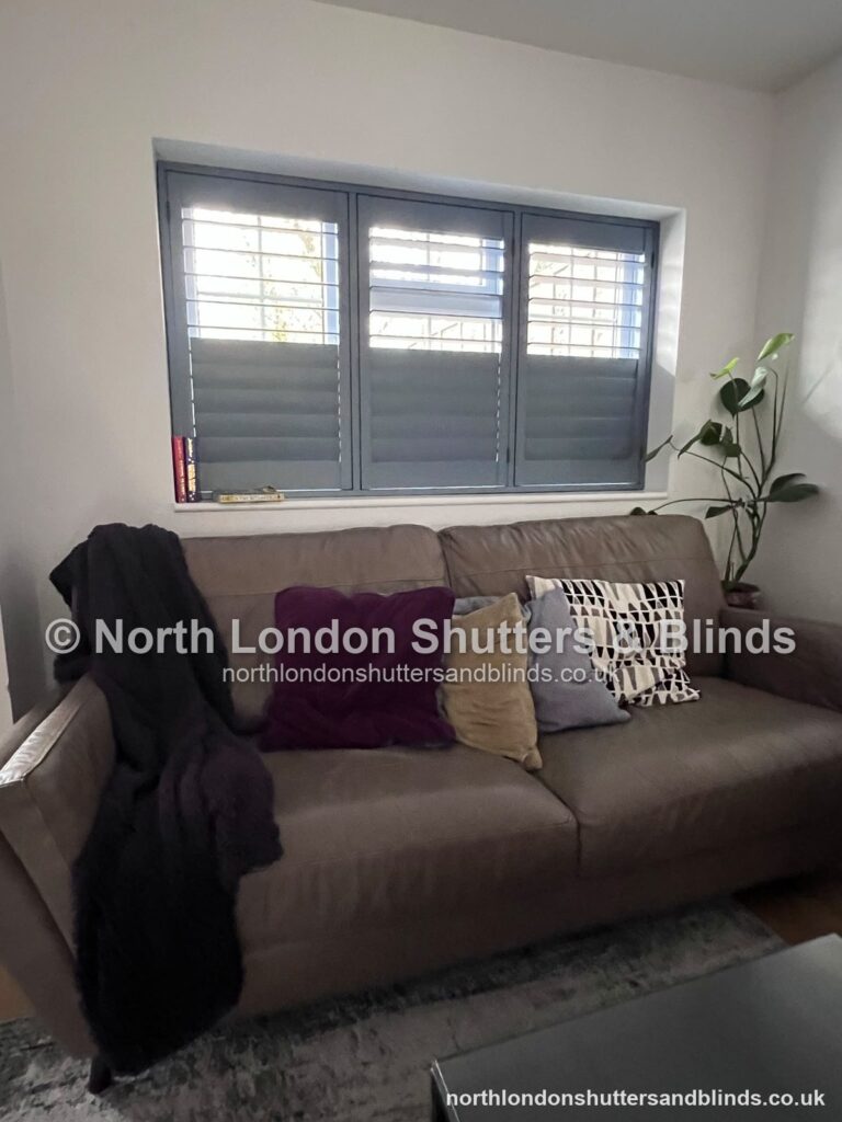 Grey full height plantation shutters in a living room, with the shutters open by shutter fitters in Barnet, North London