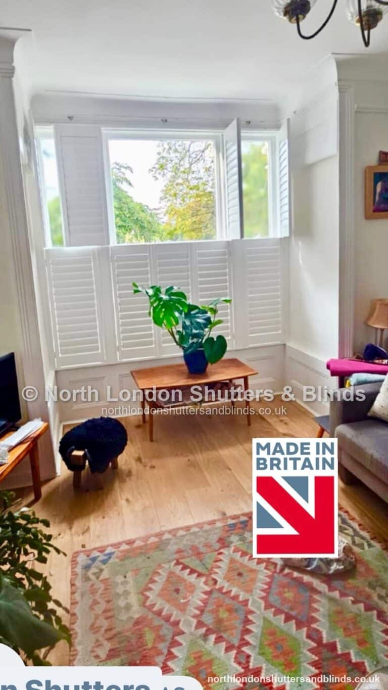 White tier-on-tier plantation shutters in a living room by shutter fitters in Barnet, North London
